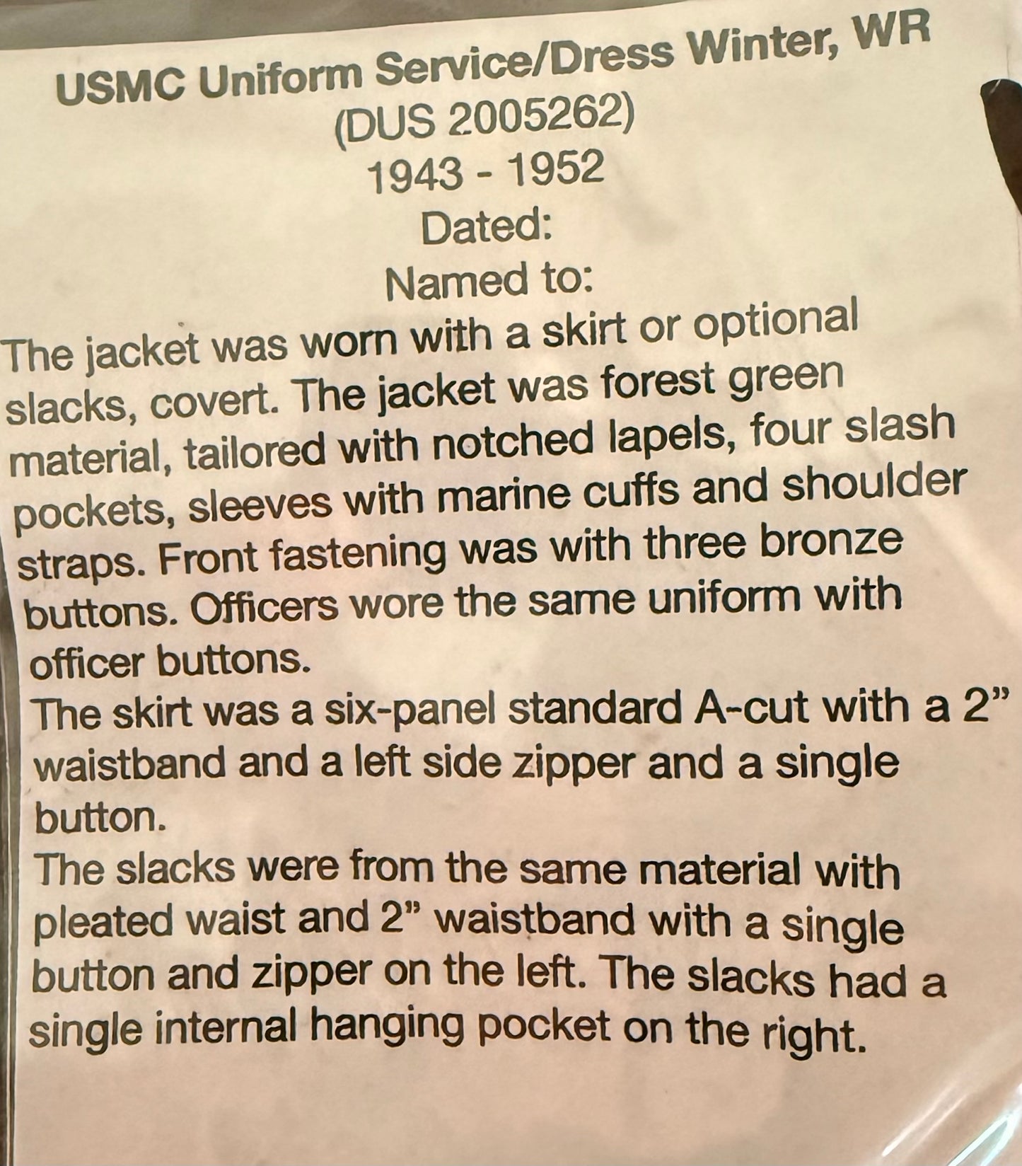 A close-up of a printed paper document describing a USMC uniform dress winter jacket from 1943-1952, with handwritten text starting 'Dated:' on a white background.