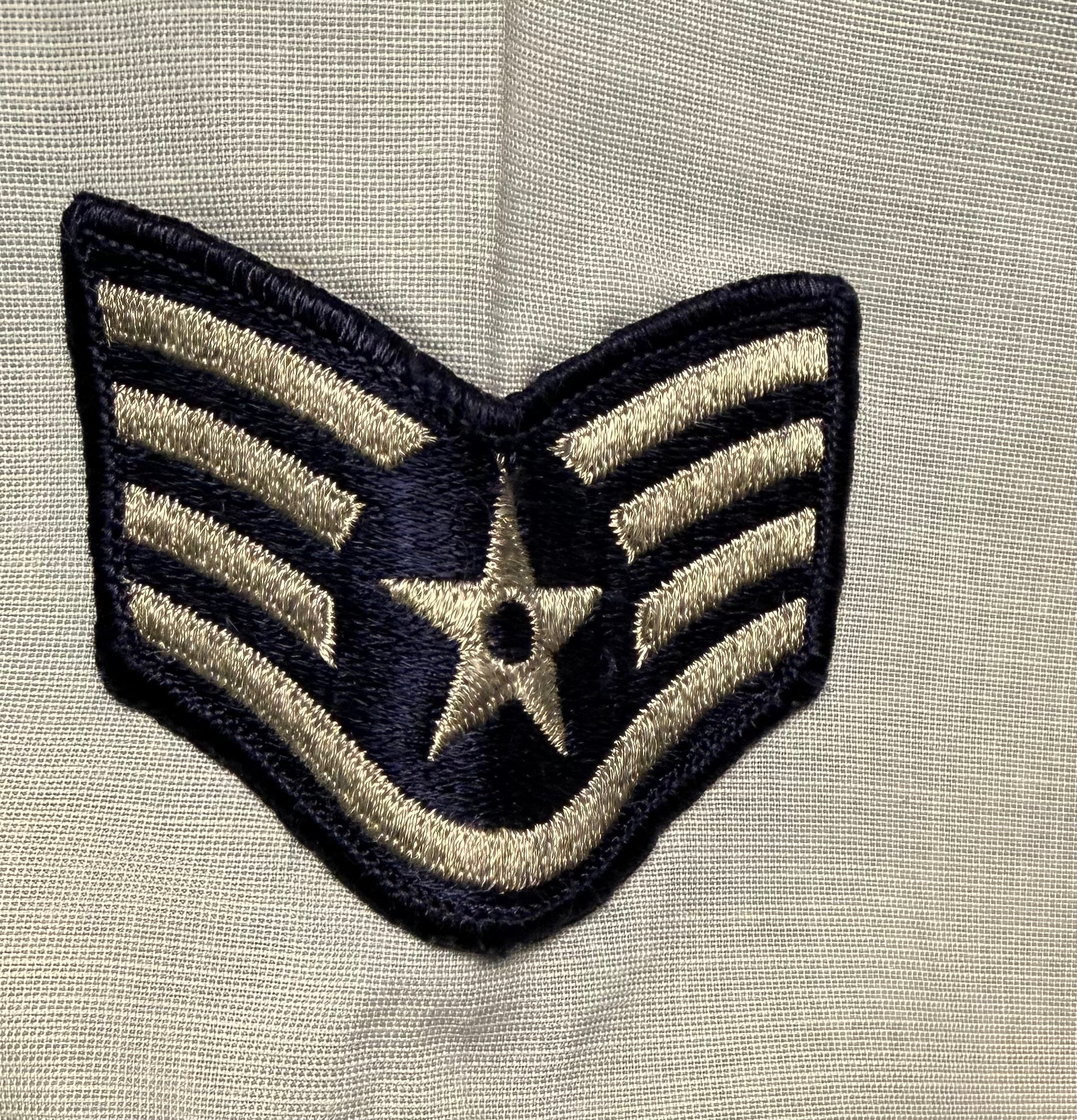 Embroidered patch with star design on a beige fabric background