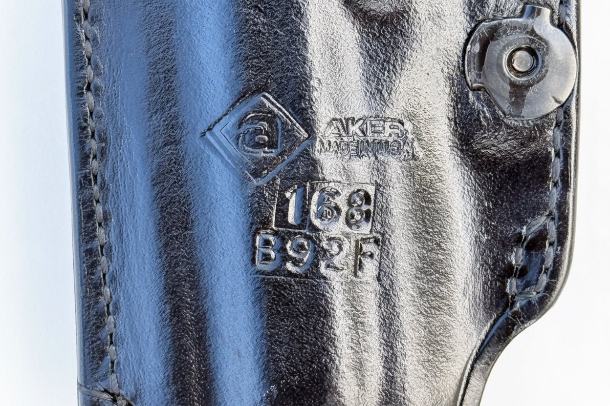 Black leather gun holster on a white background