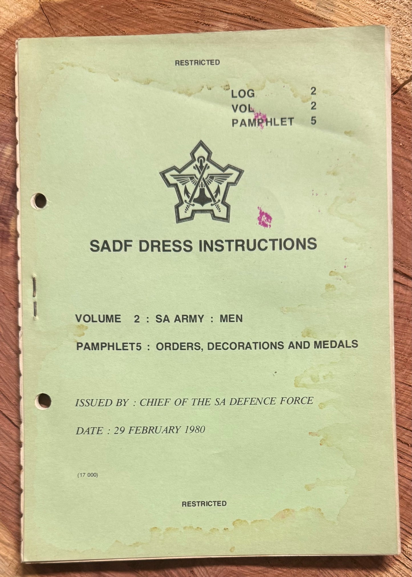 Vintage SADF Dress Instructions book on a wooden surface