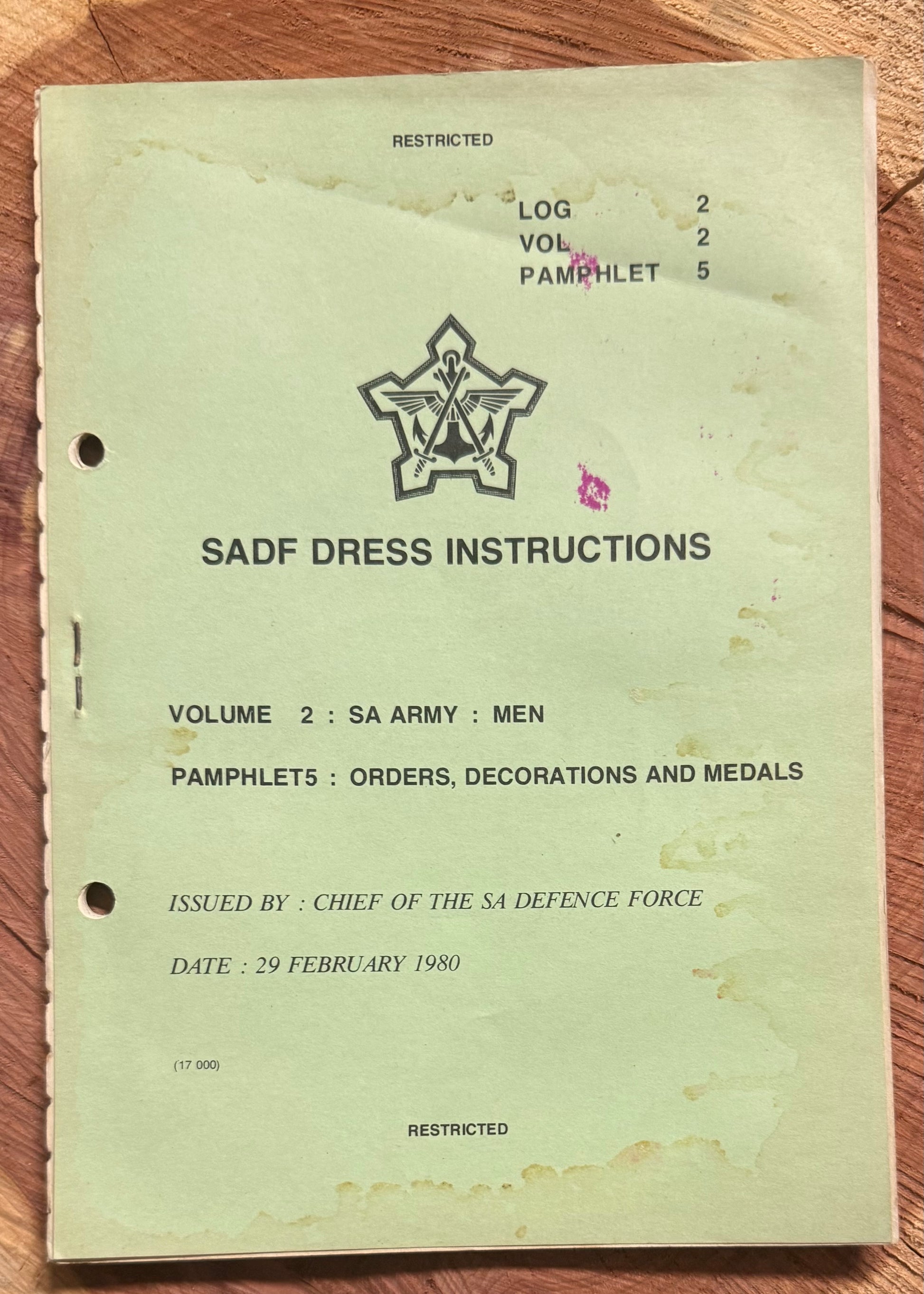 Vintage SADF Dress Instructions book on a wooden surface