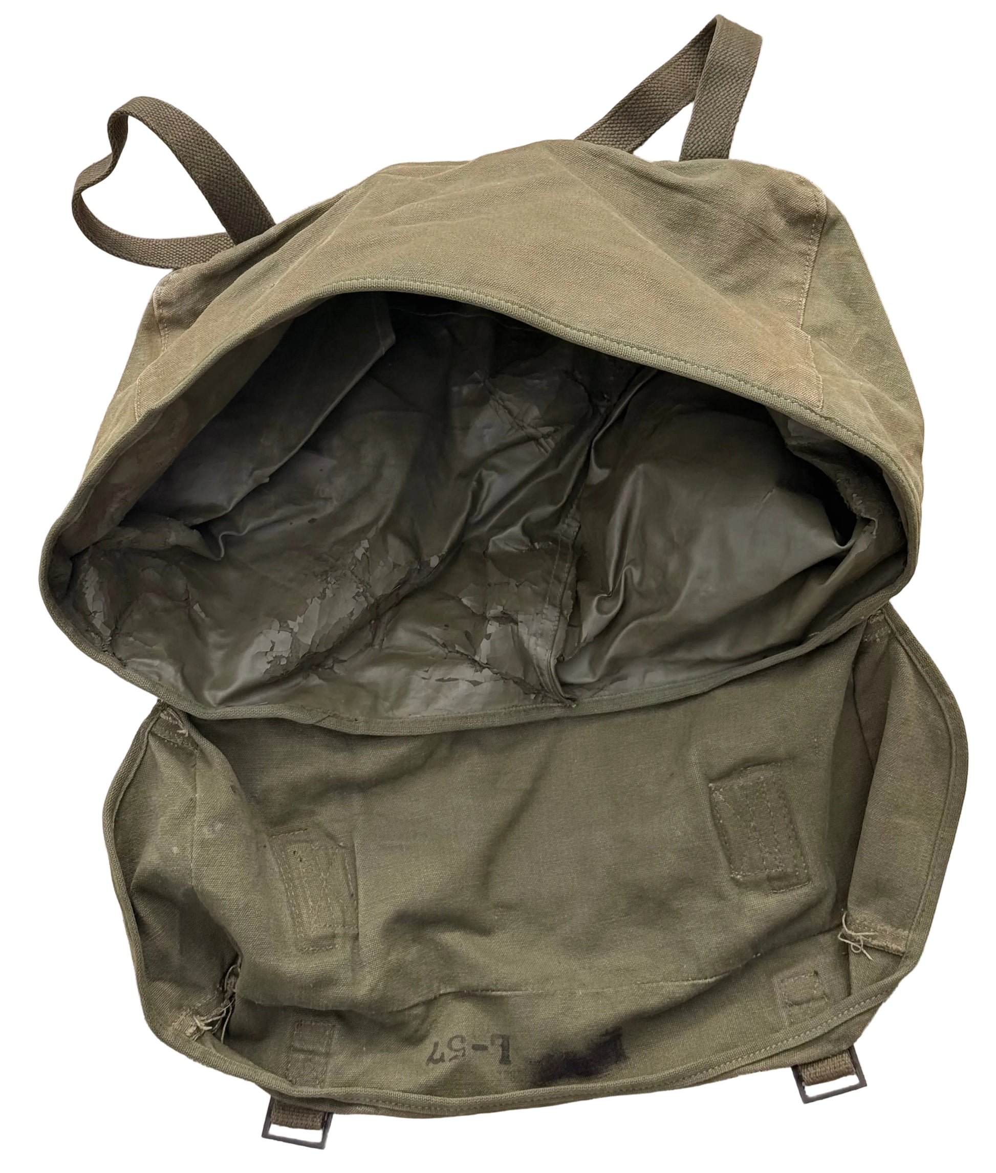 An olive green canvas backpack shown open, revealing a dark interior lining, laid flat on a textured concrete surface.