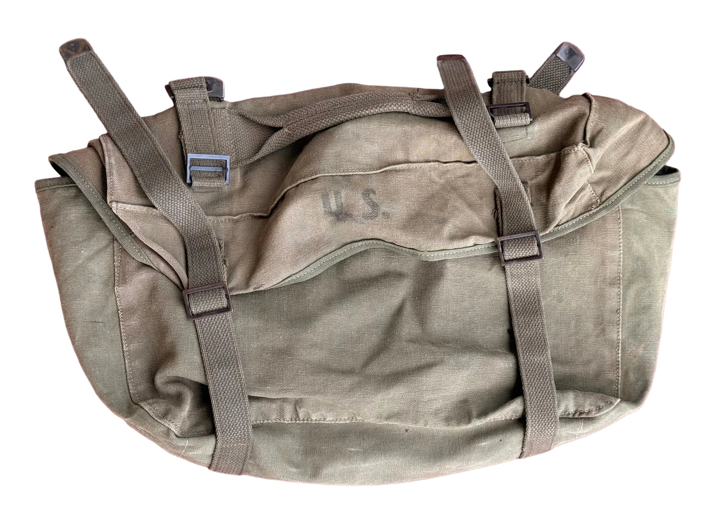 An olive drab canvas military pouch with gray webbing straps and plastic buckles, laid flat on a textured pink surface. The word 'U.