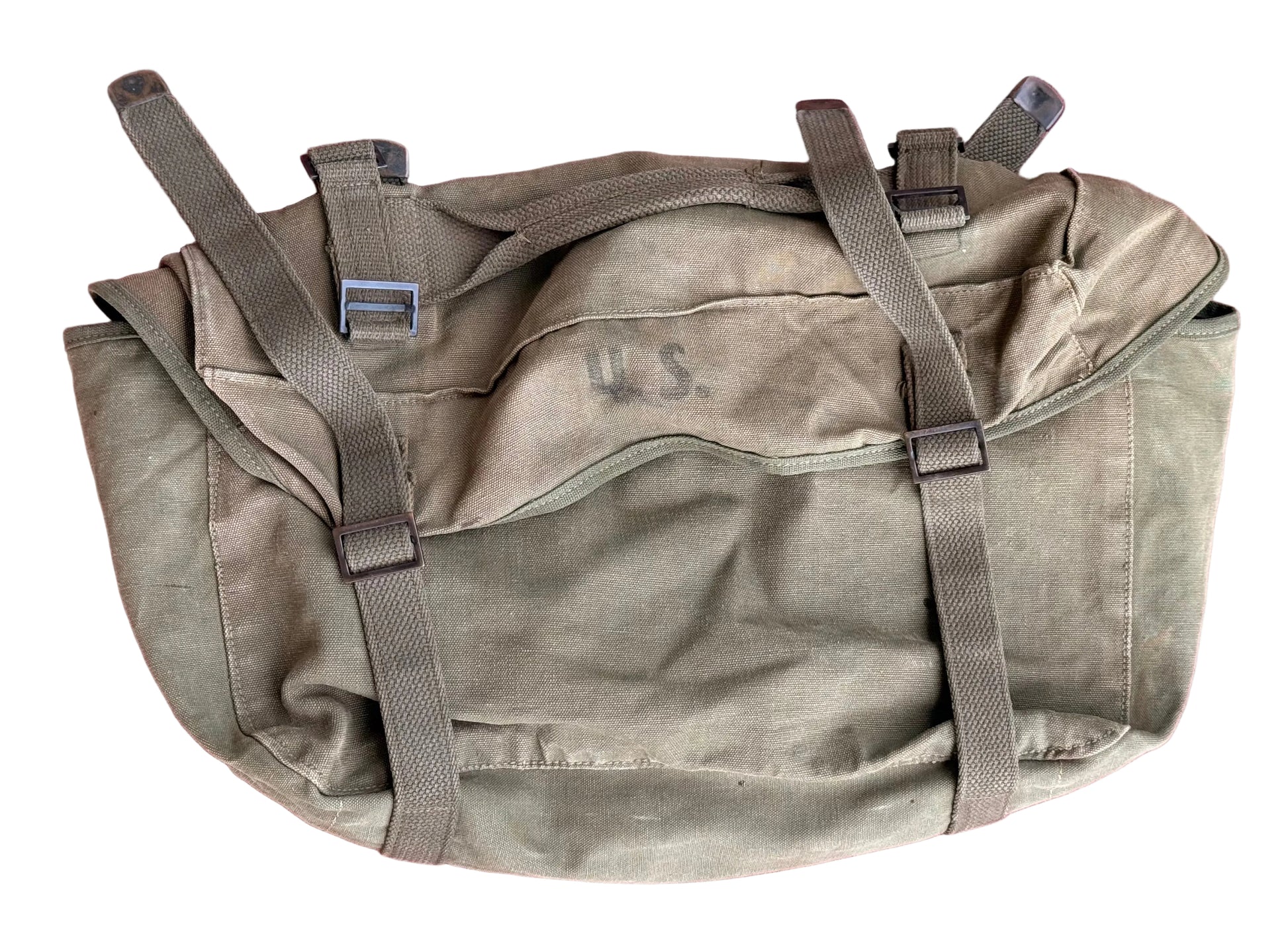 An olive drab canvas military pouch with gray webbing straps and plastic buckles, laid flat on a textured pink surface. The word 'U.