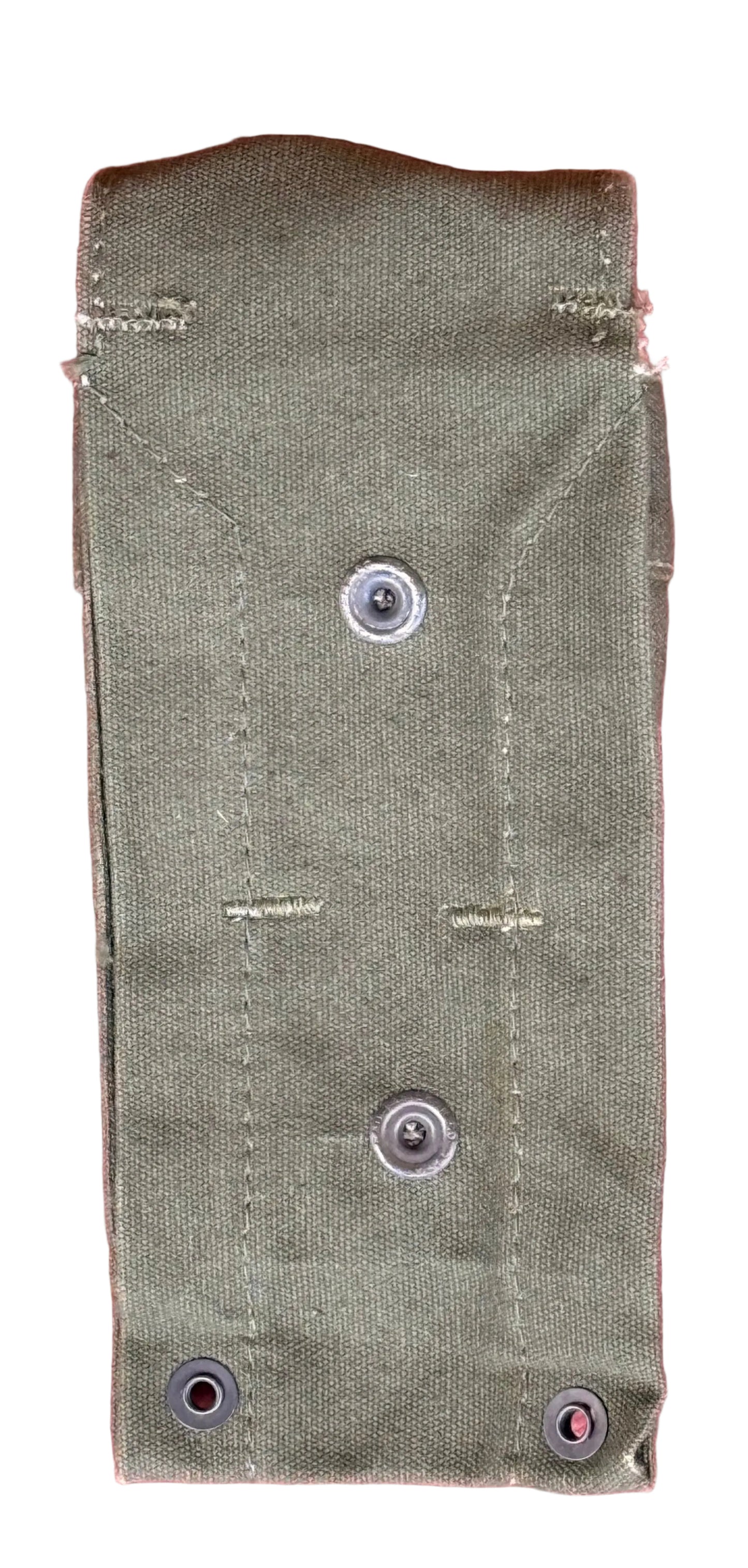 An olive green canvas sleeve or pouch with metal grommets, laid flat on a textured pink background.