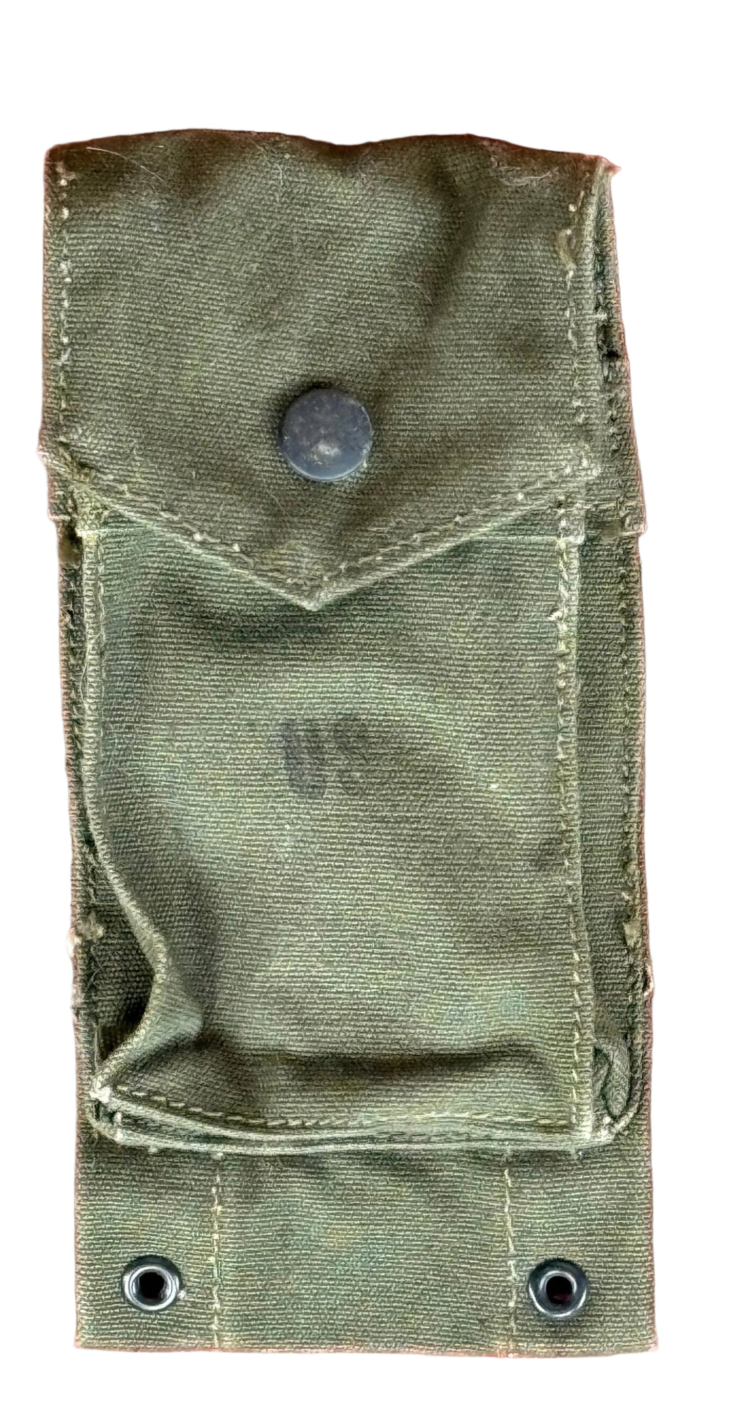 An olive green canvas utility pouch with a flap pocket and metal snap button, laid flat on a textured reddish-pink surface.