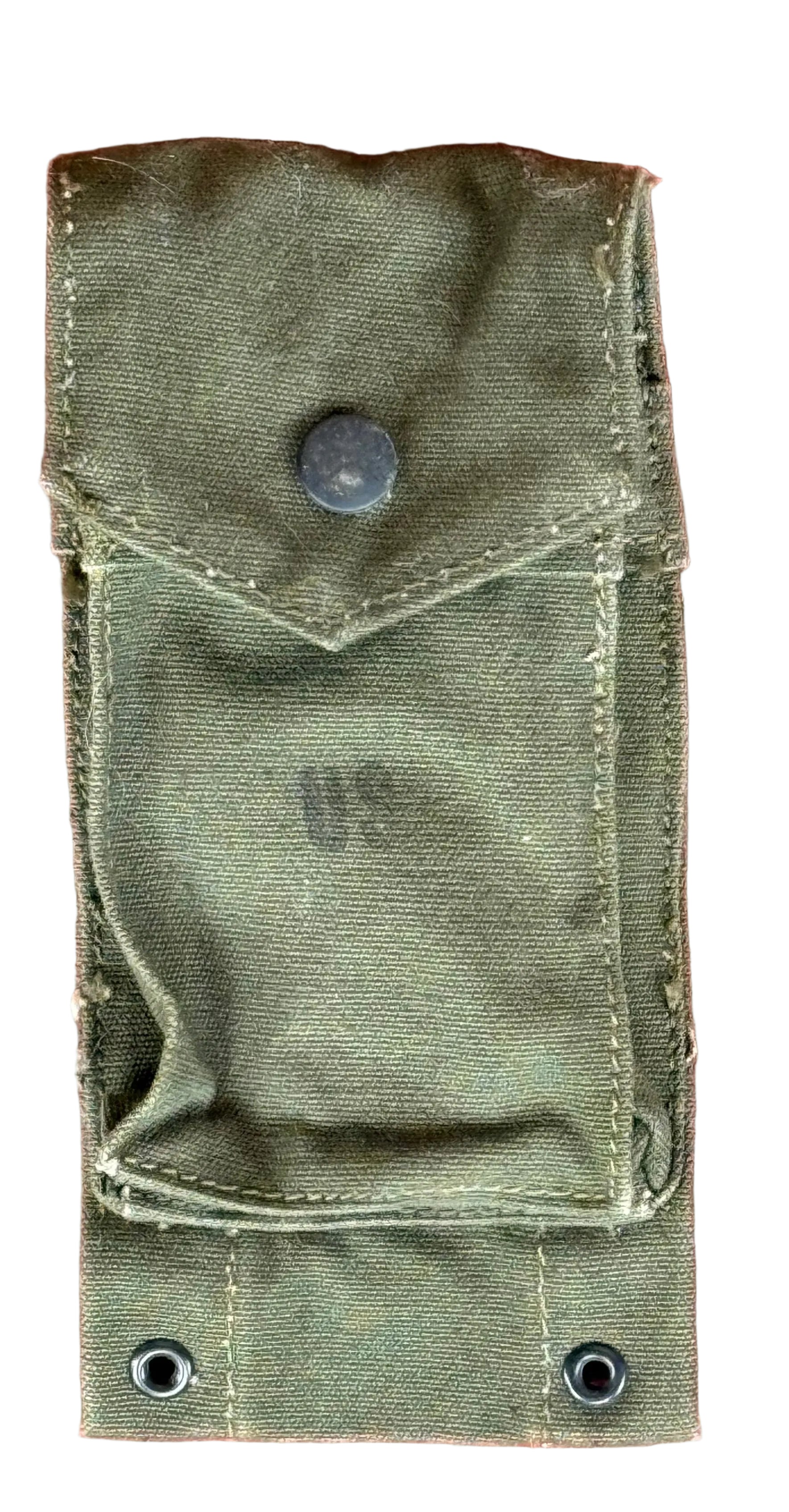 An olive green canvas utility pouch with a flap pocket and metal snap button, laid flat on a textured reddish-pink surface.