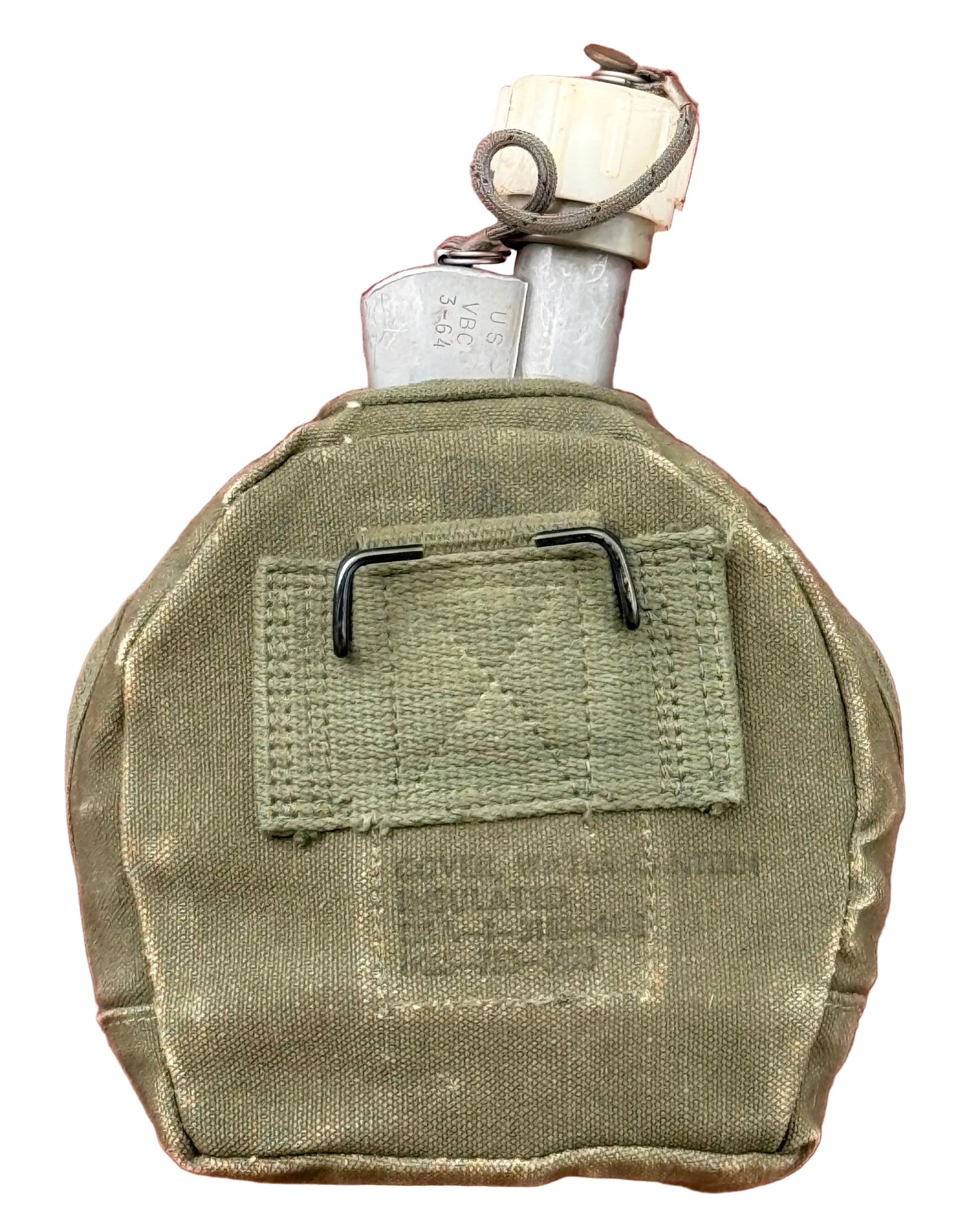An olive drab military canteen with a metal flask visible at the top, resting on a textured red surface.