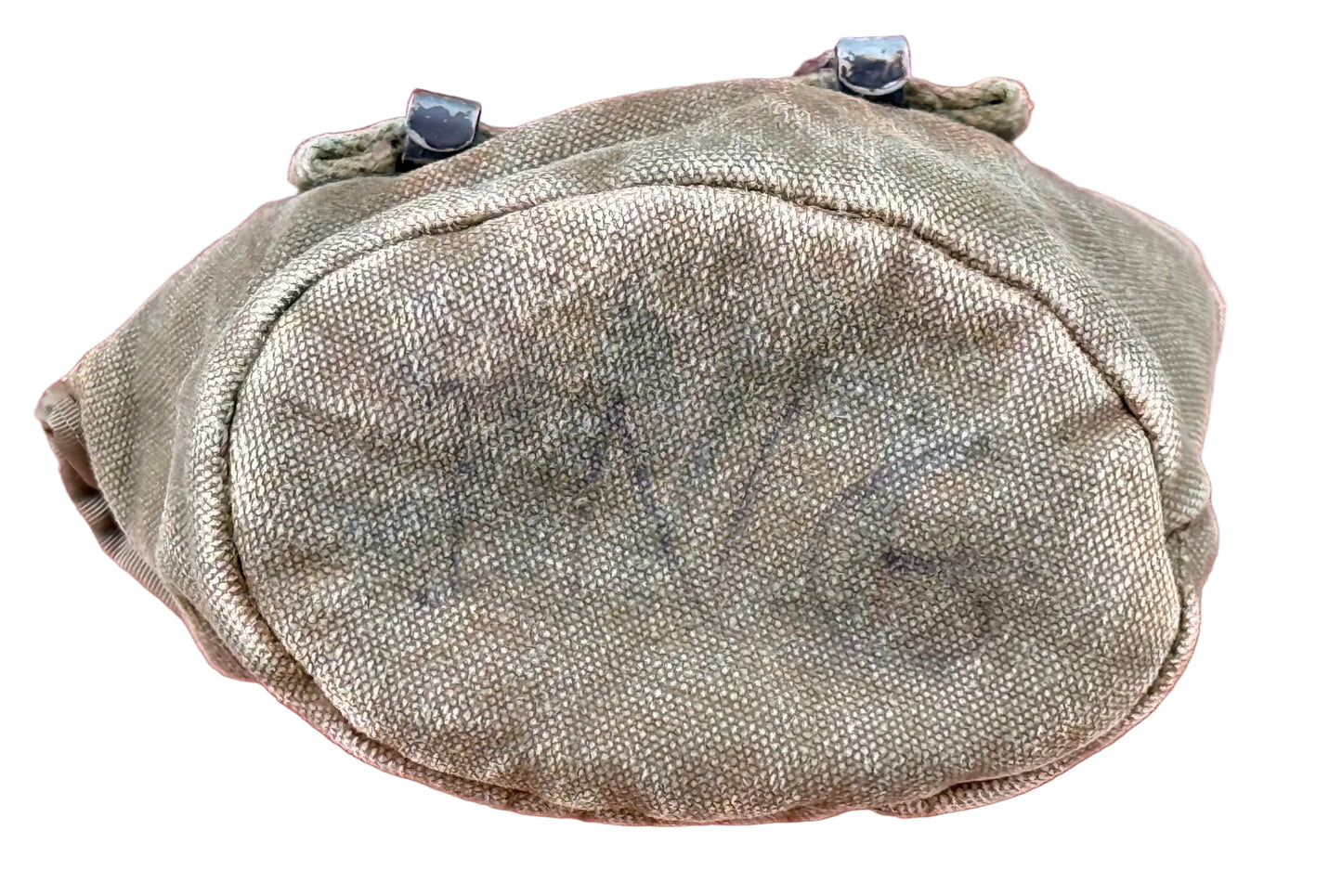 A vintage olive drab canvas pouch with black metal snap fasteners at the top, featuring faded black handwritten markings on the front, set against a textured red background.