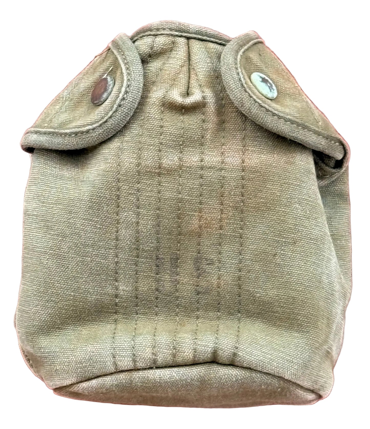 A vintage tan canvas canteen pouch with two snap-buttoned flap covers, photographed against a textured red background.