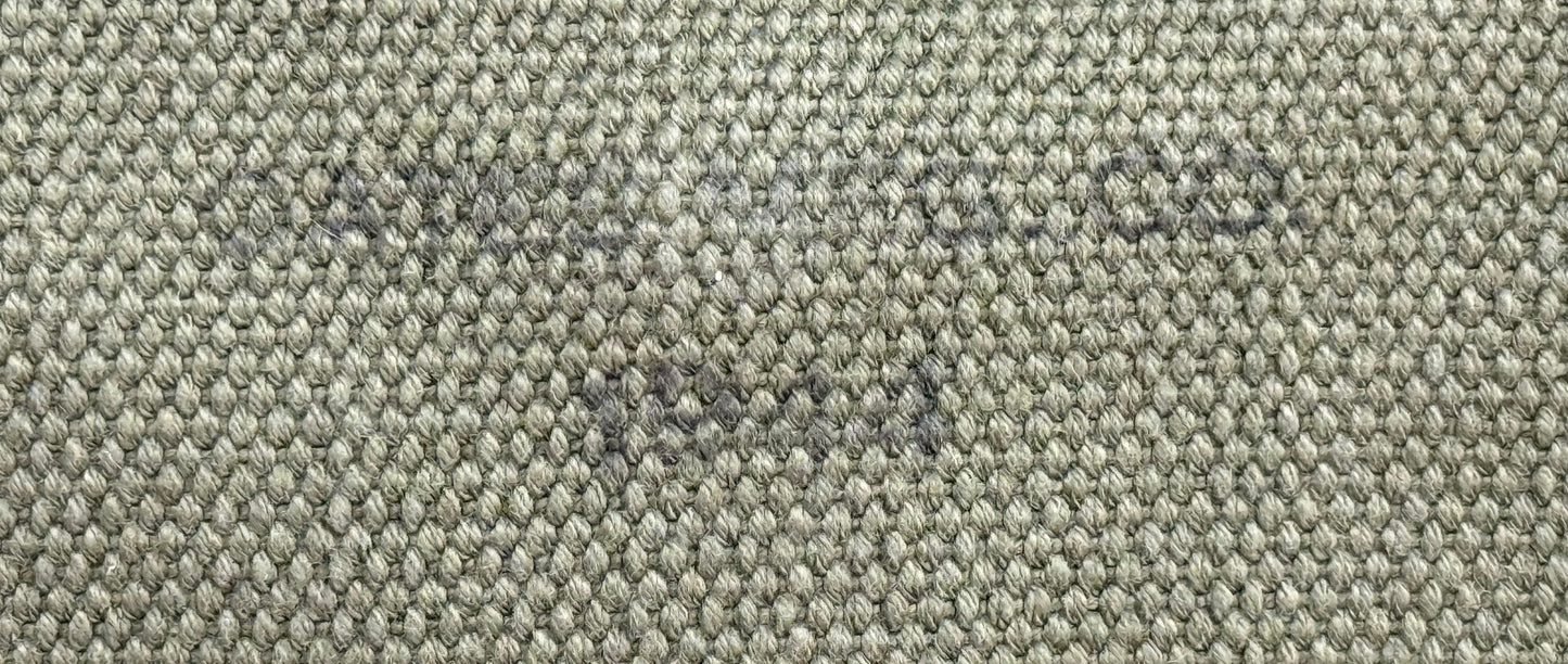 Close-up of a woven fabric texture in a heathered gray and beige colorway, showing the detailed knit pattern.