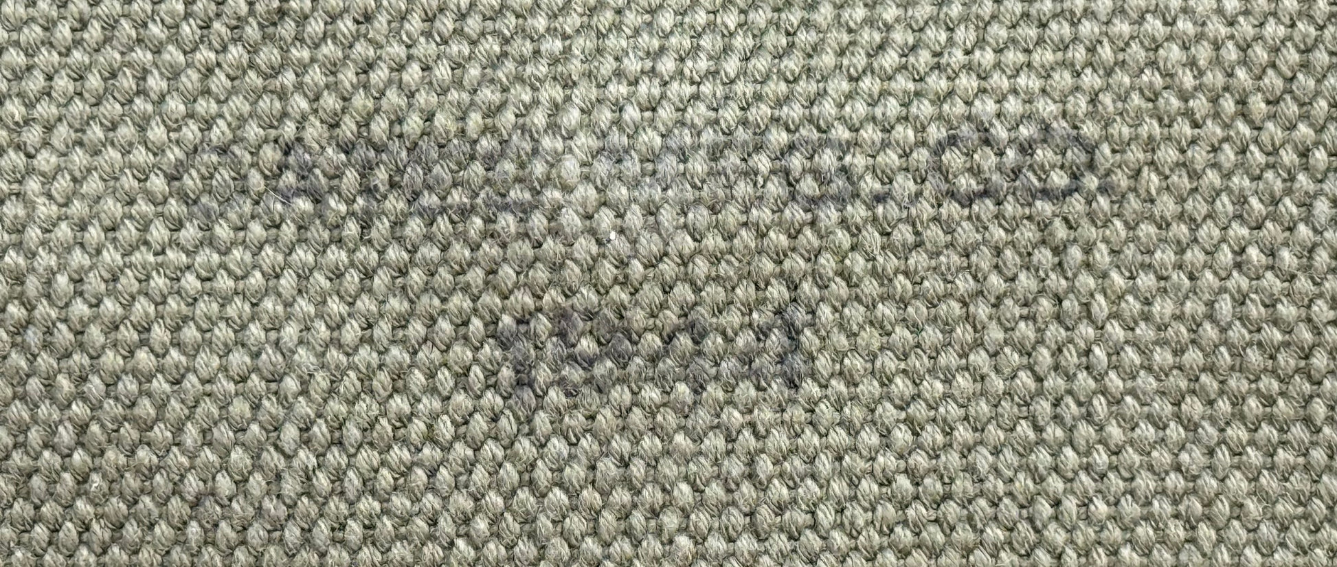 Close-up of a woven fabric texture in a heathered gray and beige colorway, showing the detailed knit pattern.