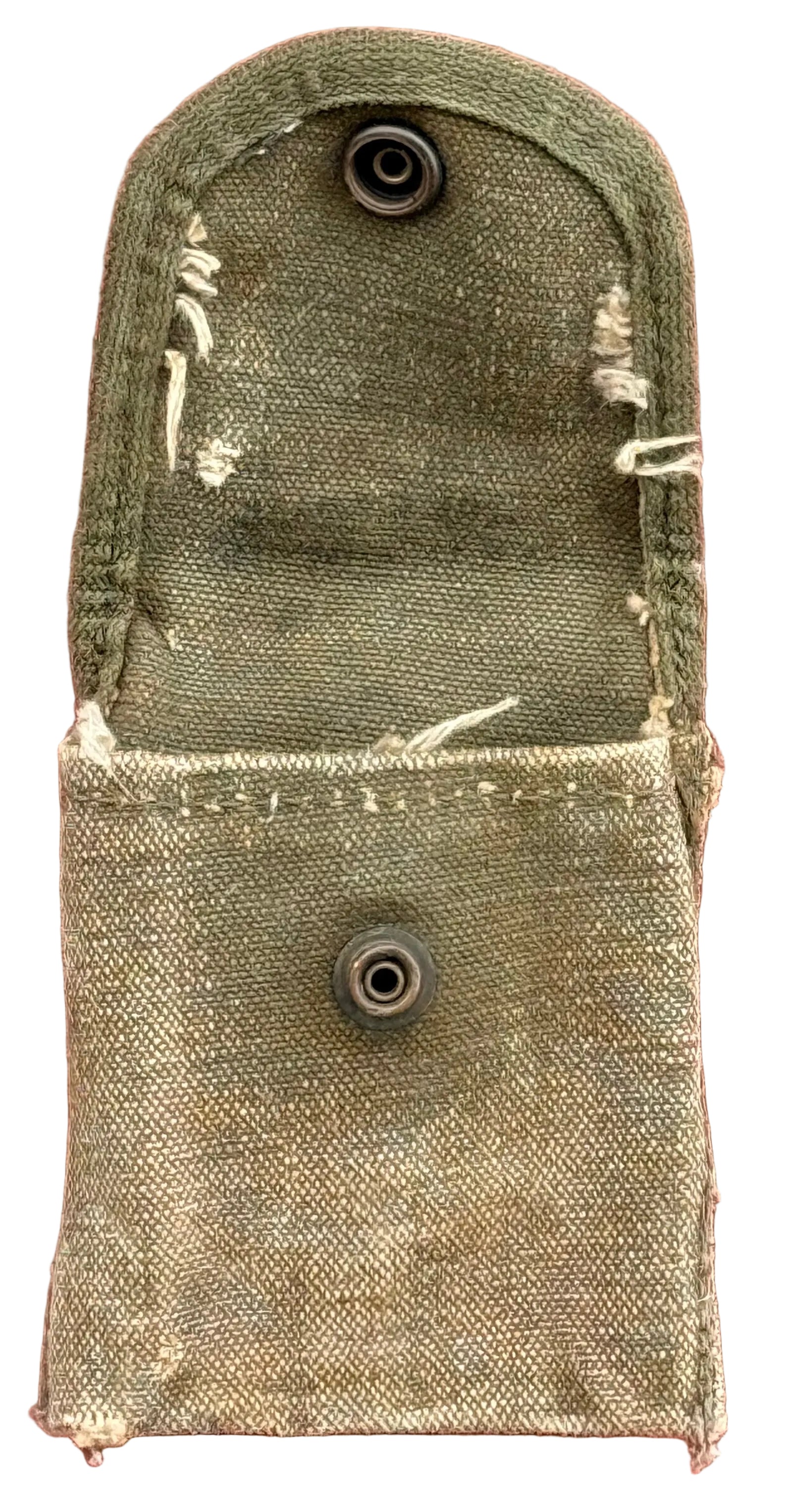 A vintage olive green canvas utility pouch with two metal snap buttons, displayed flat against a textured red background.