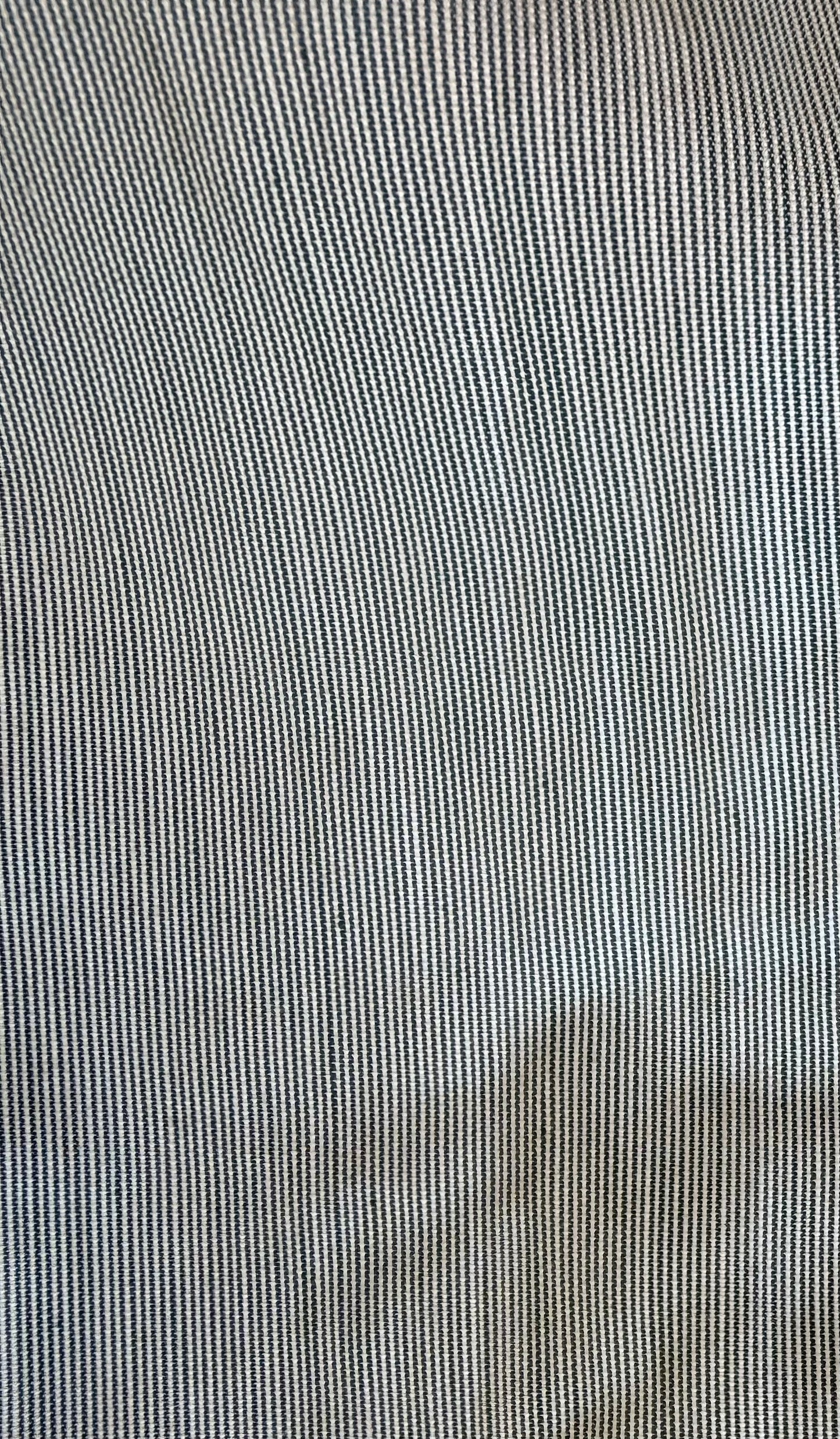 Close-up of a fine vertical striped fabric texture in light gray and white.