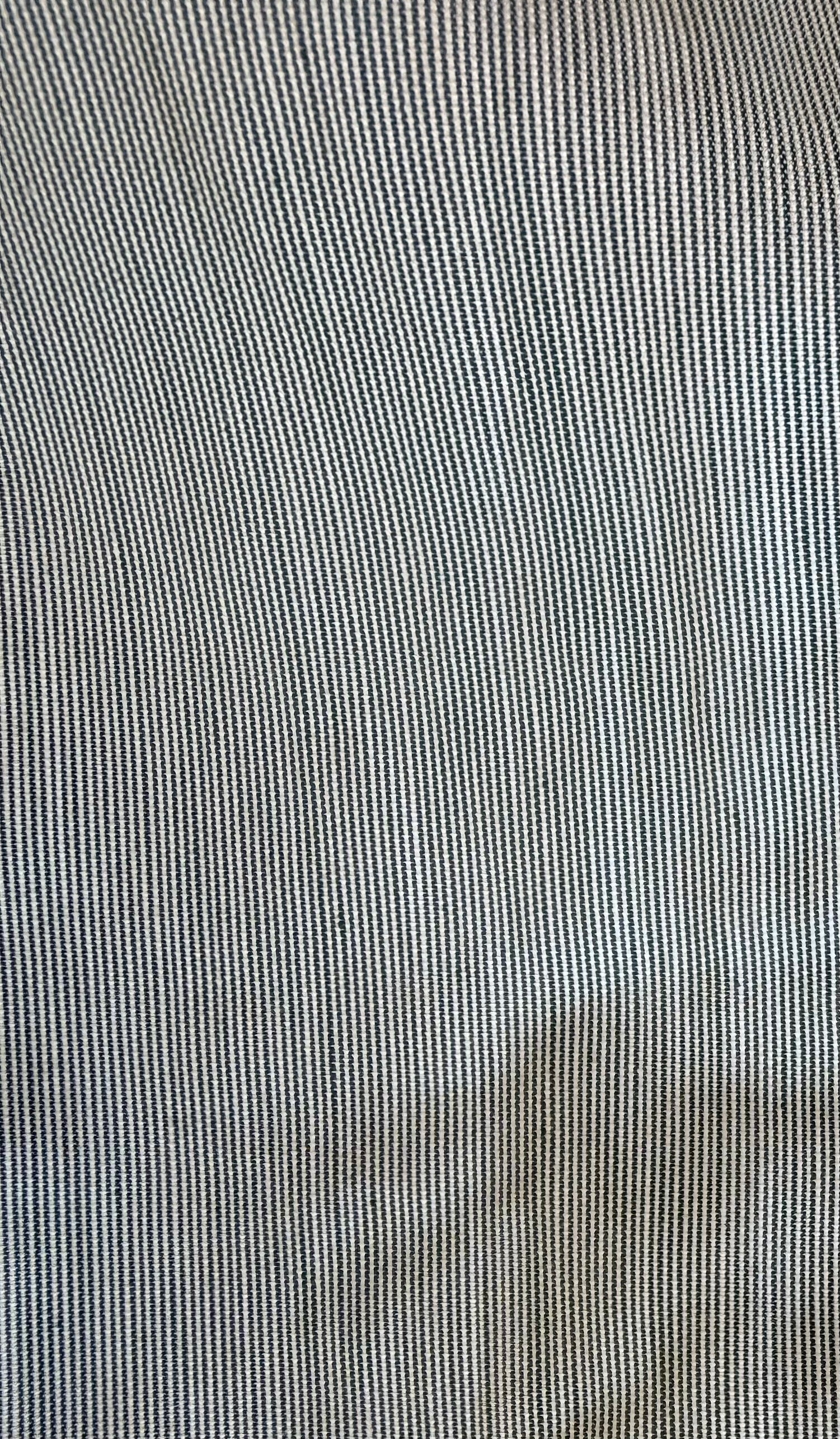 Close-up of a fine vertical striped fabric texture in light gray and white.