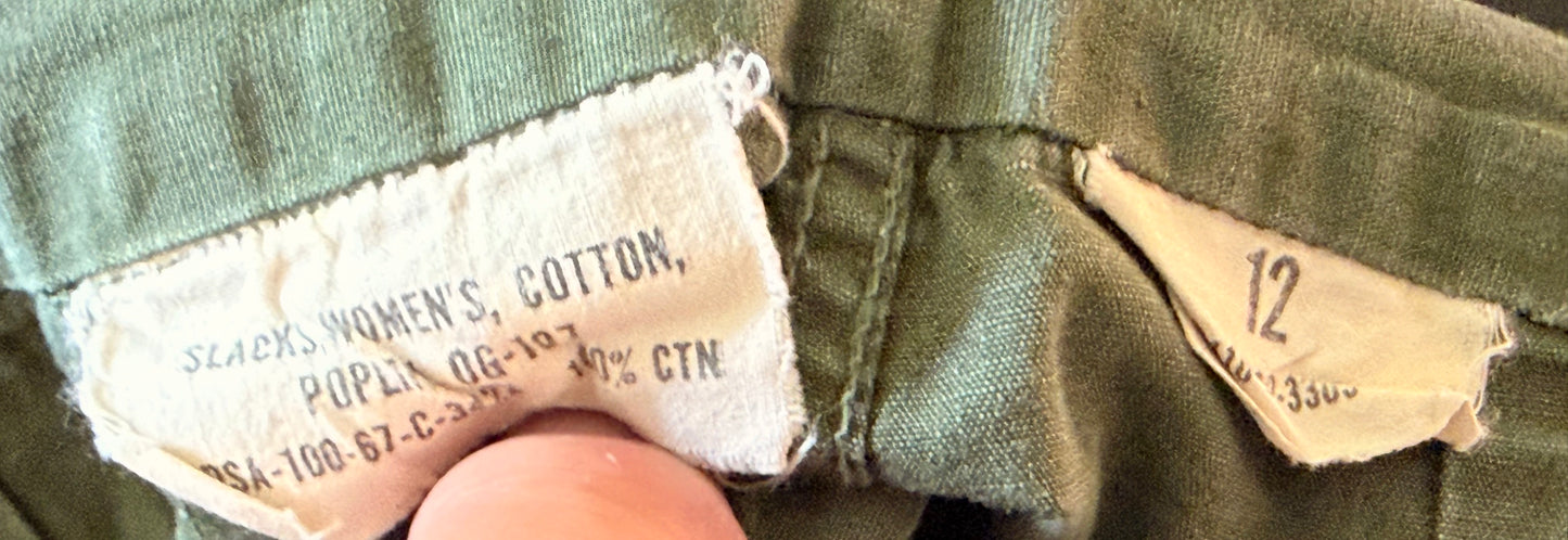 Close-up of a vintage olive green garment's inner waistband showing a cotton brand label that reads 'Sears Women's Cotton' and a size marker indicating '12'.