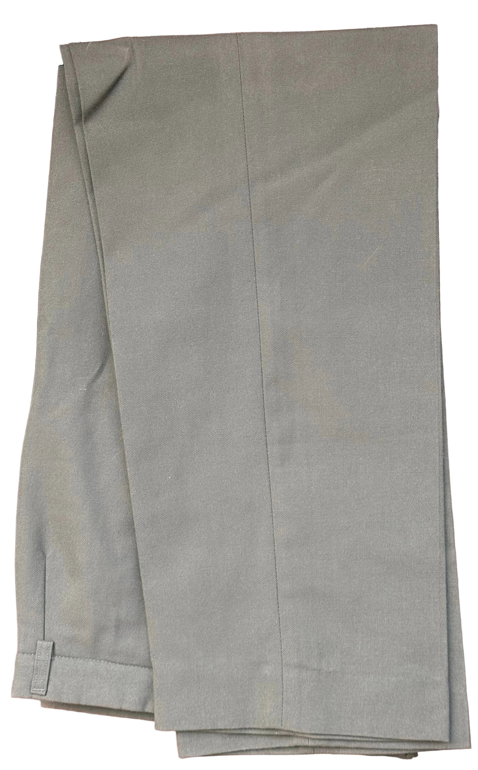 A pair of olive green trousers folded and draped over a black hanger, set against a dark brown wooden background with carved details.
