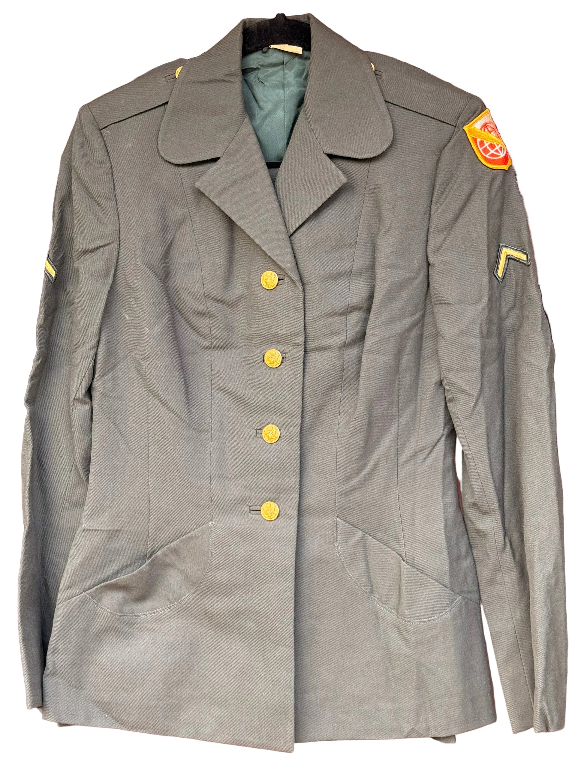 An olive green military-style double-breasted blazer jacket with gold buttons, displayed on a hanger against a carved wooden background.