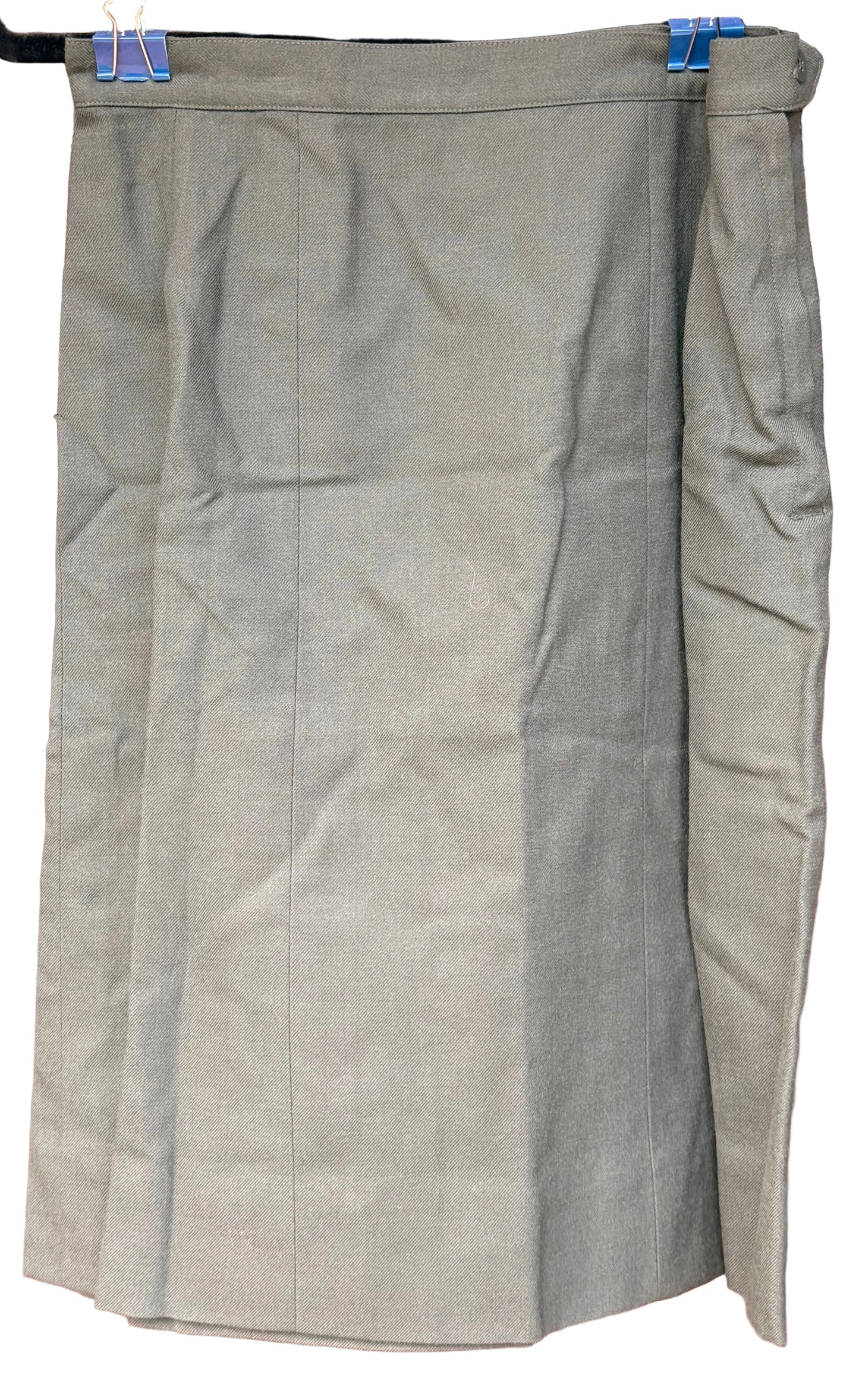 An olive green skirt with a wrap-style side slit, hanging flat against a dark wood background.