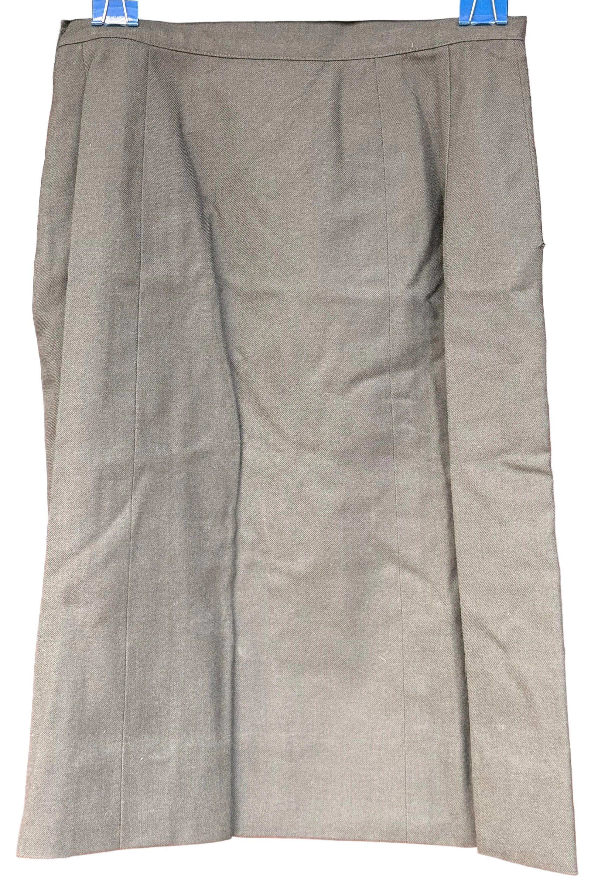 A knee-length olive green skirt with a subtle sheen, shown hanging flat against a dark wood background.