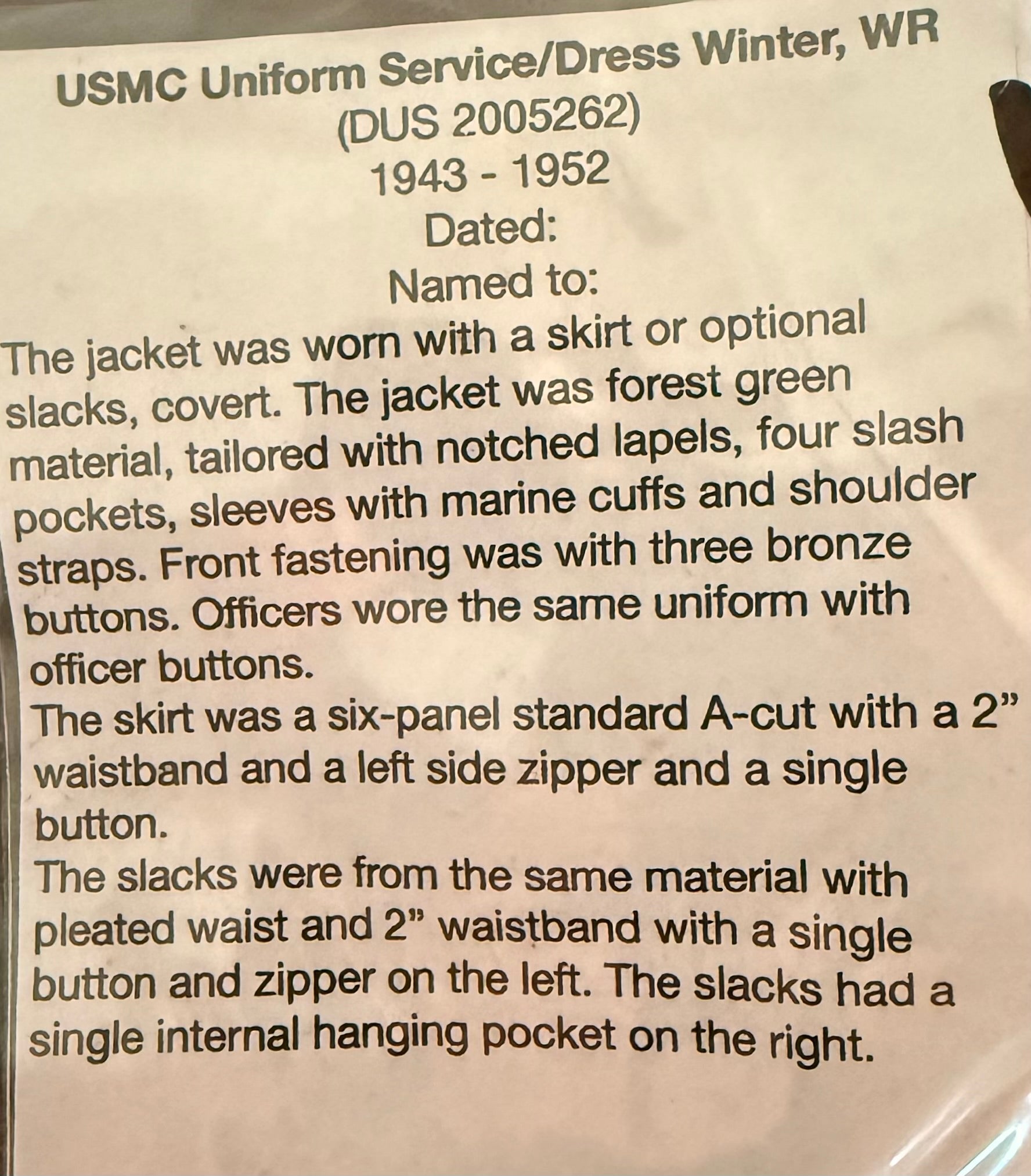 A close-up of a printed paper document describing a USMC uniform dress winter jacket from 1943-1952, with handwritten text starting 'Dated:' on a white background.